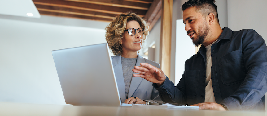coworkers talking laptop